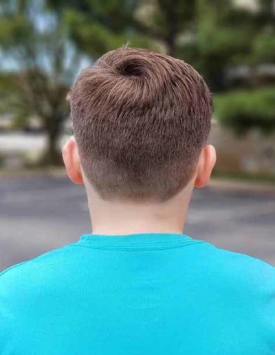 Boy with shaved haircut by New Dimensions School of Hair Design
